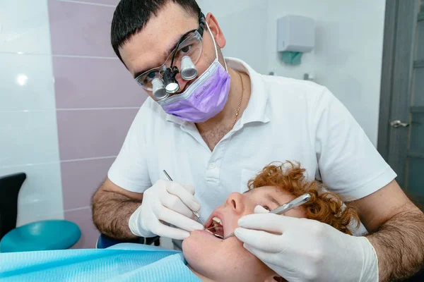 The doctor inspects the baby teeth