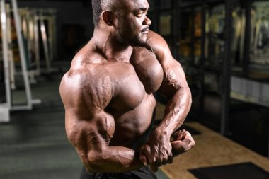 Spor salonunda poz veren Afrikalı vücut geliştirici