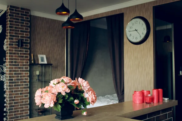 Pink roses in room and clock