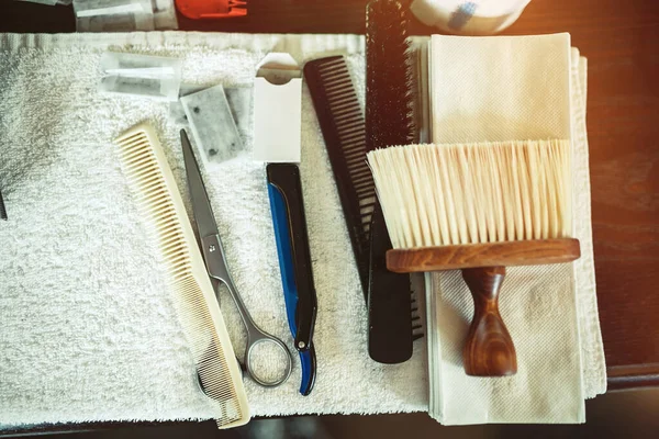 Top view of various barber tools on white towel