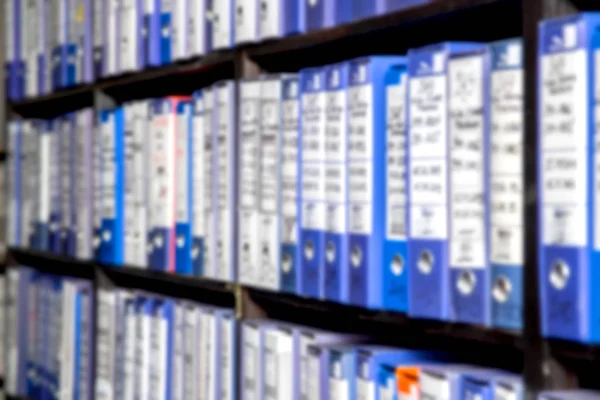 Blurred scene of shelves full of paper documents stored in an ol — Stock Photo, Image