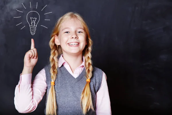 Schoolchild on blackboard background — Stock Photo, Image