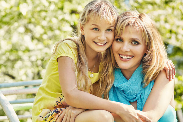 hugging happy mother and daughter