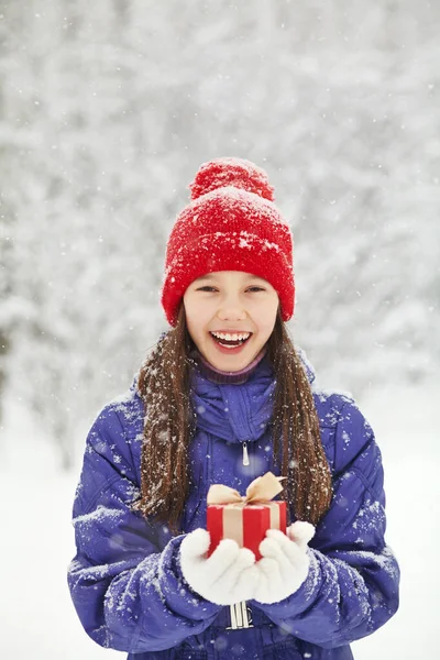 Teenage girl with a gift in her hands. adolescent winter outdoors Royalty Free Stock Photos
