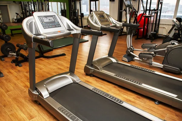 Treadmill in a gym. Fitness club equipment. Sports background. — Stock Photo, Image