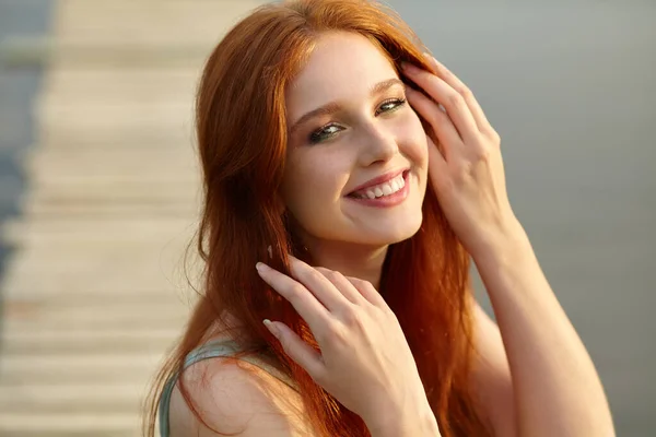 Retrato de verão de uma jovem ruiva no fundo da água no campo . — Fotografia de Stock