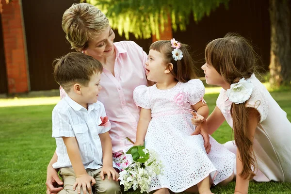 Felice famiglia giocoso all'aperto. genitori con bambini in estate. Madre e figli . — Foto Stock