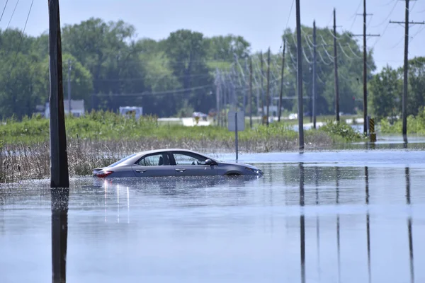 Stranded car on a flooded road Stock Picture