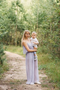 Mutlu genç aile doğada birlikte zaman geçirir. Bebekli tatlı anne