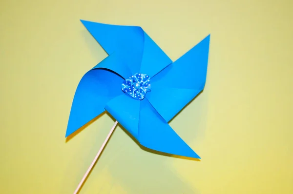 Photo of a pink fan made of paper on blue ponaveshali photos wit — 스톡 사진