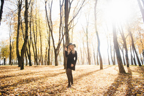 Beautiful young girl in hat in autumn Park