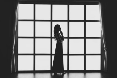 Tavan arasında arka lambası olan bir kızın silueti.