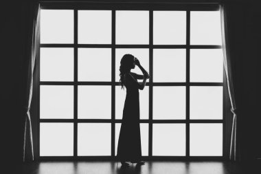 Tavan arasında arka lambası olan bir kızın silueti.