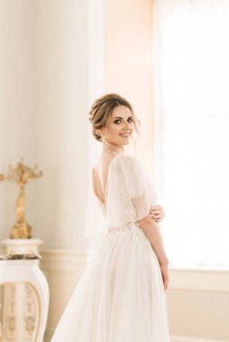 Lüks bir iç mekanda piyanonun yanında güzel bir gelinin portresi.