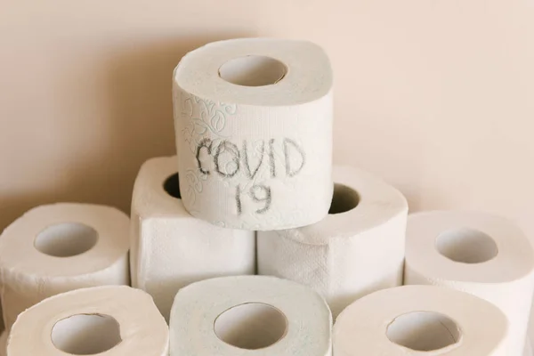 Toilet paper roll background with text toilet paper to 1 package per household. Concept of lack of toilet paper in stores due to coronavirus, Covid-19, hygiene, panic.