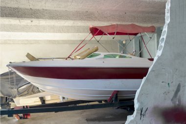 Boat parked in trailer inside marina. Indoors clipart