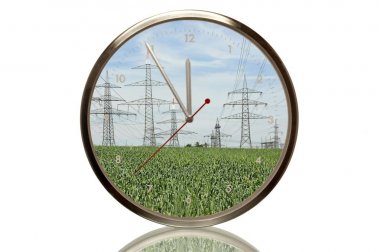 Clock with power poles, 5 minutes to twelve, eleventh hour, symbolic image for expansion of electricity networks clipart