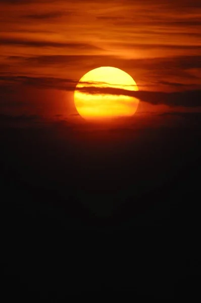 Sunset sky and big yellow sun — Stock Photo, Image