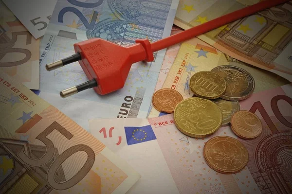 Energy costs symbolic image, euro banknotes and plug