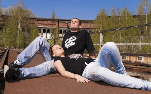 Couple Sunbathing Ground Old Railway Control Center — Stock Photo, Image