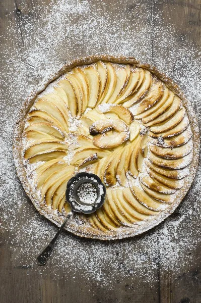 cooking Apple pie, apple tart from shortcrust with powdered sugar