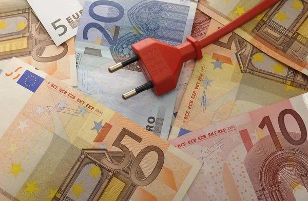 Energy costs symbolic image with banknotes and plug