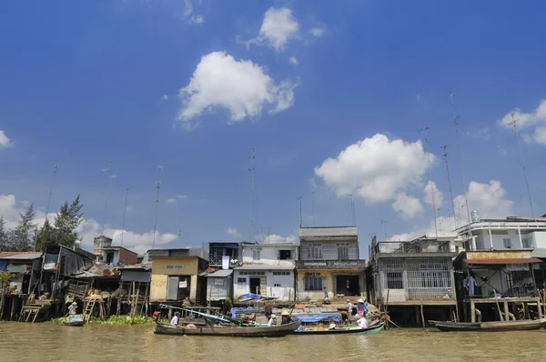 Residential dwellings and shops with numerous TV antennas on the roofs on the banks of the Mekong River, Mekong Delta, Vietnam, Asia