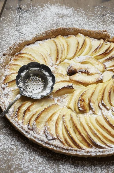 cooking Apple pie, apple tart from shortcrust with powdered sugar