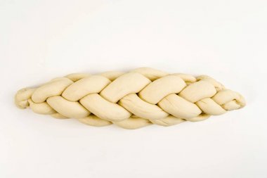 Braided bread or plaited loaf, unbaked clipart