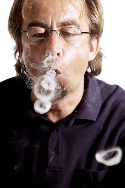 Smoker blowing smoke rings