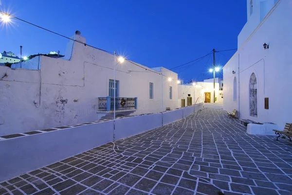 Alley at night with artificial lighting, paving stones with tiles and white joints, Milos, Plaka, Cyclades, Greece, Europe