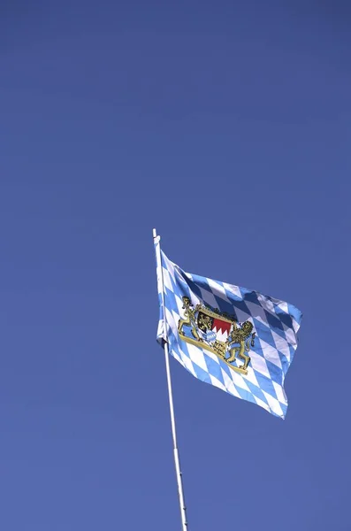 Coat of arms of the Free State of Bavaria on a chequered pattern on a flattering flag