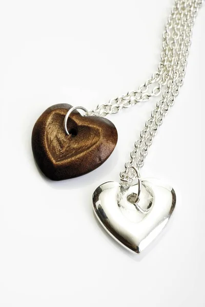 Wooden and Silver heart pendants — Stock Photo, Image
