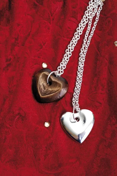 Wooden and Silver heart pendants — Stock Photo, Image