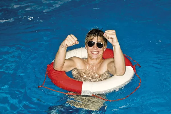 Jovem Usando Óculos Sol Flutuando Com Salva Vidas Uma Piscina — Fotografia de Stock