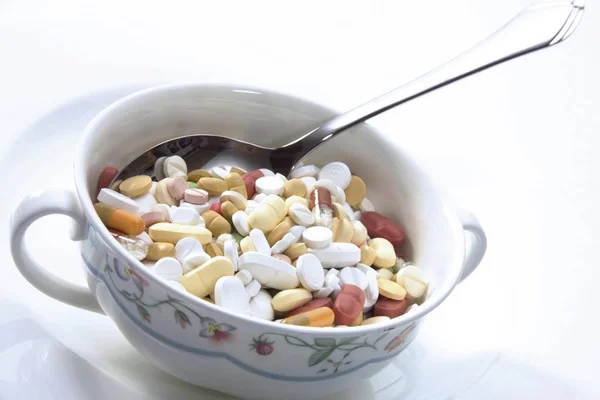 A soup bowl full of pills: symbol for dieting obsession