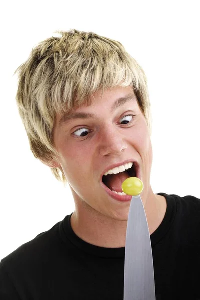 Young Man Eating Grape Point Large Knife — Stock Photo, Image