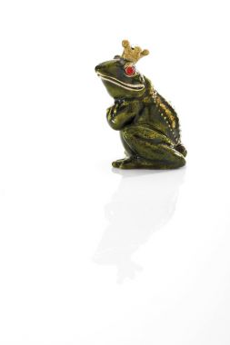 Frog figure toy with crown isolated on white clipart