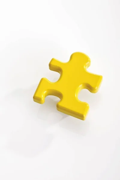 Yellow Puzzle Piece Isolated Light Background — Stock Photo, Image