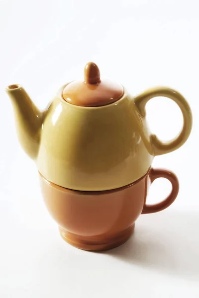 Tea for one: small teacup and teapot, stacked