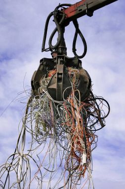 Excavator with cables against blue sky  clipart