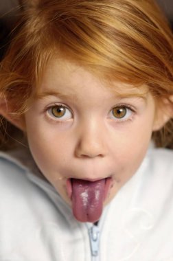 Girl with 4 years and blue coloured tongue from blueberries Vaccinium clipart