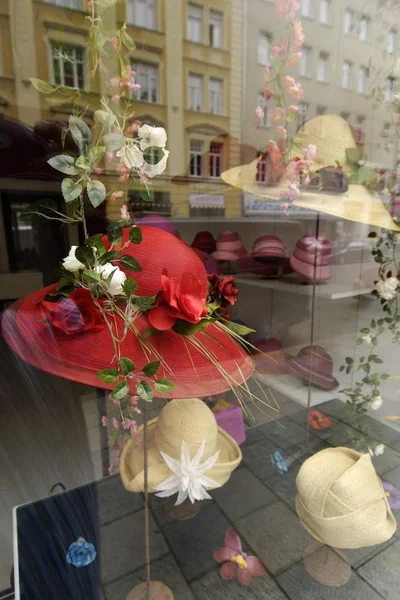window in shop, hats and flowers sale