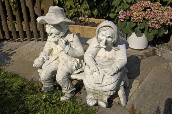 garden decor, aged man and woman figurines