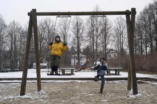 Two Boys Swings Playground Winter — Stock Photo, Image