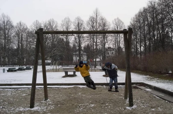 Two Boys Swings Playground Winter — Stock Photo, Image