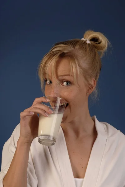 若い女性は牛乳を一杯飲む — ストック写真