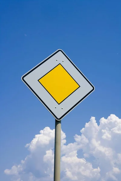 Priority road sign over clear sky