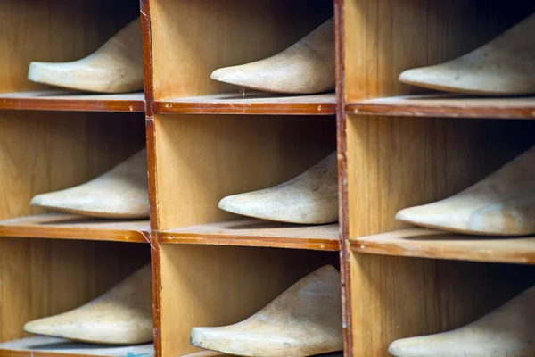 Shelf with antique lasts for manufacturing shoes — Stock Image Shelf Antique Lasts Manufacturing Shoes Stock Photo
