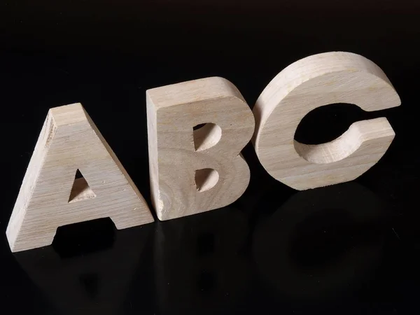 Alphabet Wooden Letters Black Surface Abc Symbolism — Stock Photo, Image